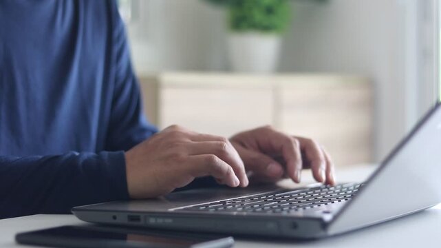 Cybersecurity, Cyber security 2FA login concept. Close-up of man's hands typing password on laptop keyboard and using smartphone for two-factor authentication, ensuring data security, online privacy. 