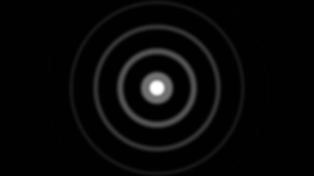 Four glowing white points with concentric circular waves pulsing on a solid black background