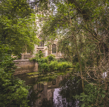 All Saints Parish Church in St Ives, Cambridgeshire, England. Seen through the beautiful trees surrounding the River Great Ouse.