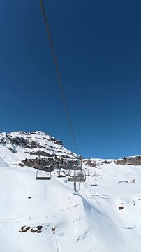 First person view riding a ski lift in the dolomites