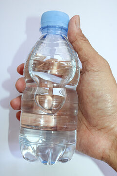 Person Hand Holding Small Bottle Of Pure Mineral Water Close Up
