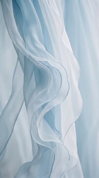 Soft flowing light blue and white fabric with elegant curves and gentle folds