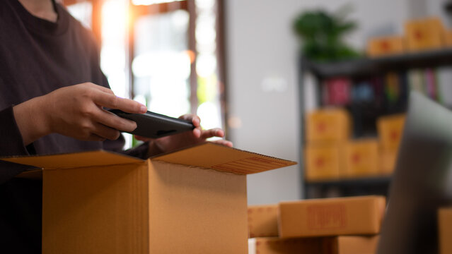 Warehouse operator scans package barcode for order fulfillment, inventory tracking, e-commerce logistics, shipping verification, warehouse management, parcel processing, and delivery accuracy.