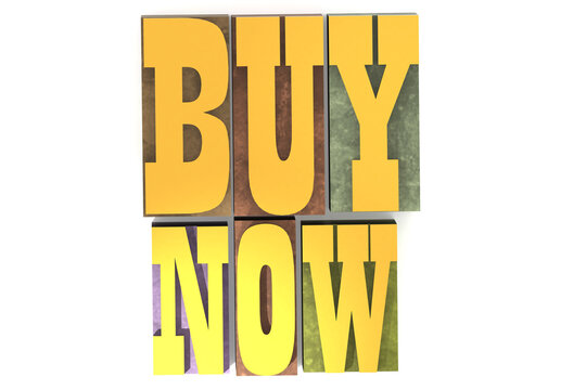 Buy now word on the colorful block. Old vintage letterpress concept