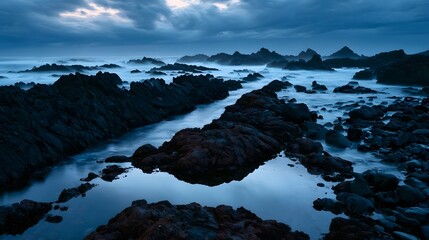 Fototapeta premium Jagged volcanic coast at dawn with tide pool