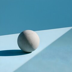 Fototapeta premium Minimalist geometric concrete sphere on pale blue