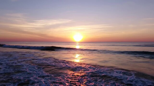 Golden sun rising over calm ocean
