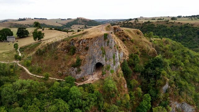 Thor's Cave is a wonderful natural cavern formed in a limestone crag and located within the Manifold Valley, Staffordshire, UK. 4k drone footage. 