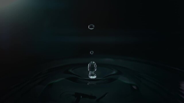 Super Slow Motion Shot of Water Drop Falling into Water Surface at 1000fps.