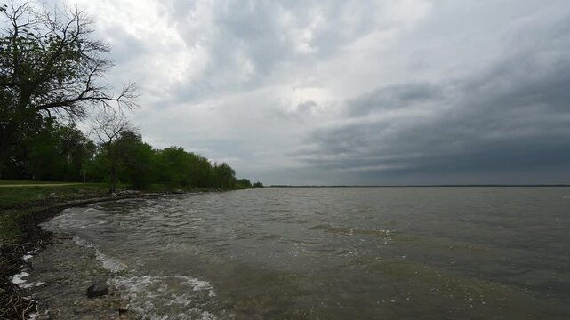 Waves breaking on the shore of a large lake on a stormy summer afternoon