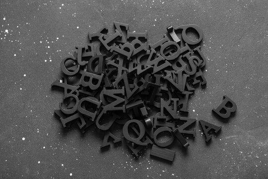 Many English letters on dark background