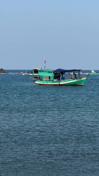 Landscape a traditional fishing village in Rachvem Bay on Phu Quoc Island, Vietnam. Boat in sea. Traditional fishing boats are moored to rickety wooden in local fishing villages. Sea beach is by calm 