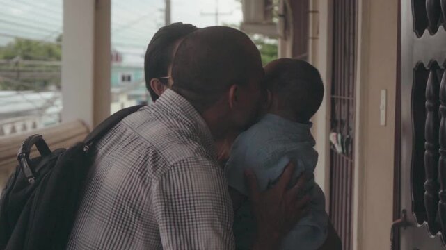 Hispanic father returning home from work