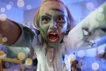 Child with zombie makeup reaching forward indoors © Pixel-Shot