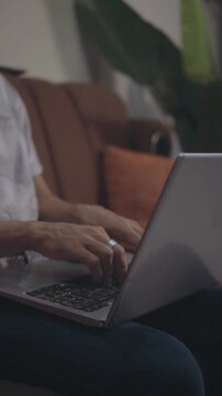 Person working remotely on laptop computer at home