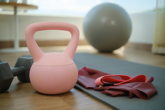 Home workout equipment arranged beside an exercise mat, ready for a personal fitness session.