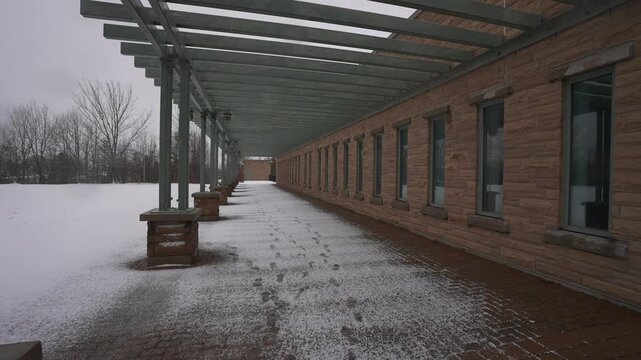Ajax Water Supply Plant, exterior industrial facility architecture tracking shot during sleet storm, Ontario, Canada, winter, rotating camera angle, dolly movement.