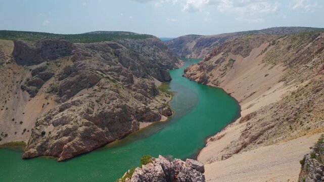 High angle view of tourists admiring the Zrmanja River canyon meanders from Parizevacka Glavica viewpoint in Croatia