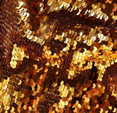 Gold sequin texture background with reflective sparkling . Abstract christmas backdrop, wallpaper.