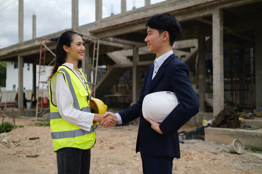 Construction professionals shaking hands after reaching a project agreement on site.