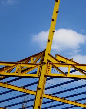 The yellow steel construction frame of the building