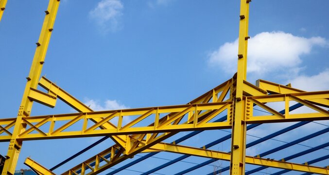 The yellow steel construction frame of the building