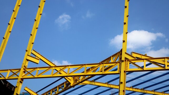 The yellow steel construction frame of the building