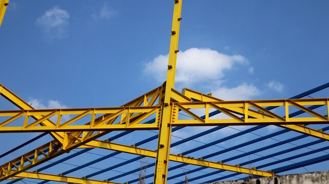 The yellow steel construction frame of the building