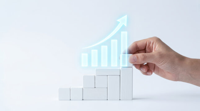 Hand arranging white block steps with glowing key performance indicator KPI bar graph and upward arrow representing business growth