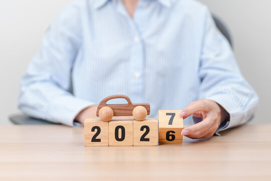 2026 end year to Happy New Year 2027 with Car model on table. Automobile Tax, Car Insurance, Financial, vehicle Repair and Maintenance and New Year concept