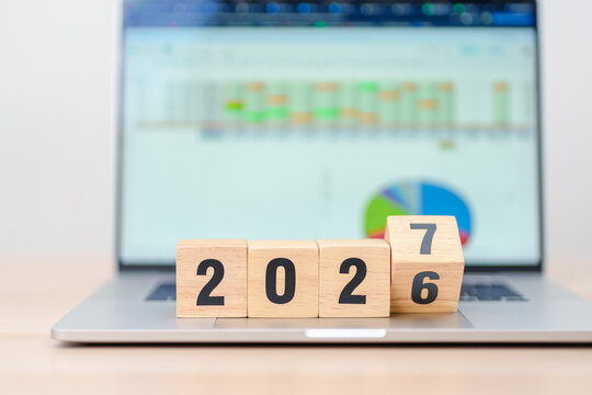 2026 end year to Happy New Year 2027 block with computer laptop background. Goal, Target, Resolution, strategy, plan, Action, mission, motivation, and New Year start concepts