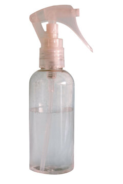Clear spray bottle containing a colorless liquid with a pink trigger nozzle. Ideal for showcasing beauty and wellness products. Health. And cleanliness concepts