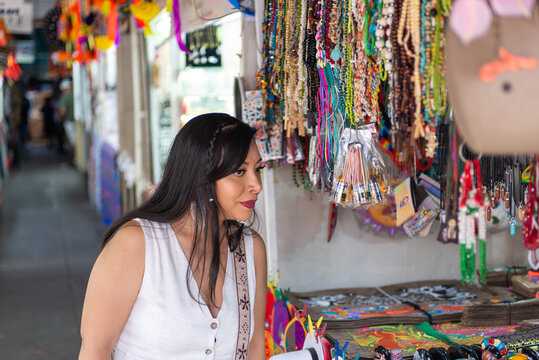 Woman Browsing Handmade Souvenirs and Traditional Necklaces at Mexican Market
