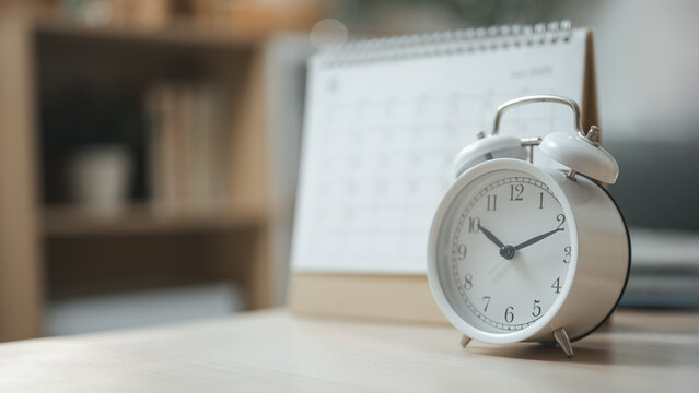 Alarm clock and calendar represent bill payment reminders, recurring expenses, and budgeting to avoid late fees and manage finances efficiently.