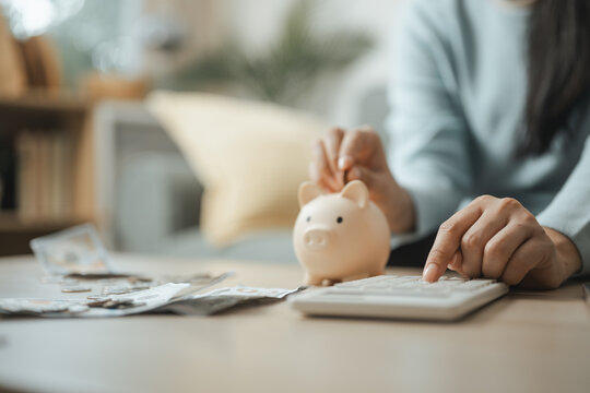 Personal budgeting with a piggy bank, calculator, and cash highlights saving, expense tracking, and financial planning for future stability.