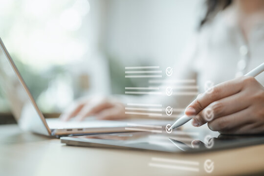 Professional completing a digital checklist on a tablet with a stylus, representing approval, inspection, workflow and business productivity.