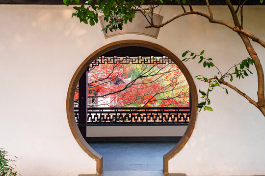 Circle gate with red maple leaves during the autumn foliage season in Hangzhou, China