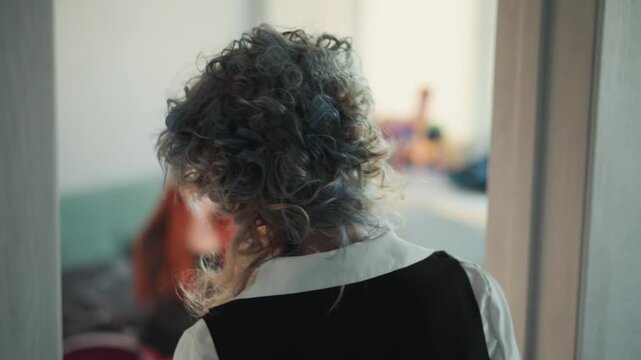 Candles tarot reading caucasian fortune teller, elderly curlyhaired reader leans over candlelit cloth while redhead client sits on bed, cards spread, smoke and hush, tense anticipation in bohemian