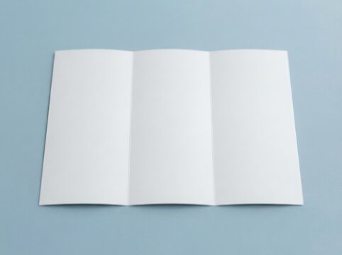 Blank tri fold brochure mockup on light blue surface for product presentation