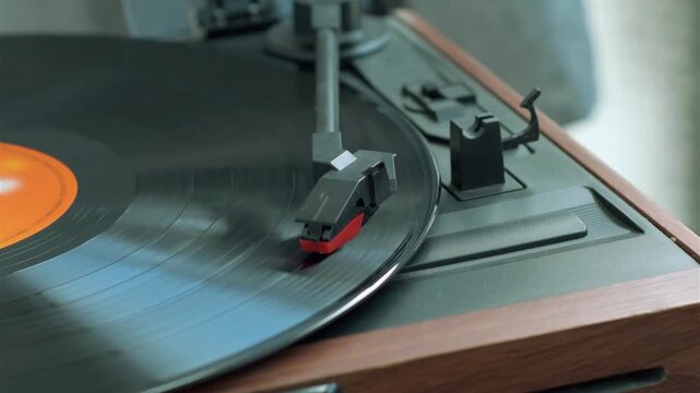 Vinyl record playing on an old style turntable with stylus