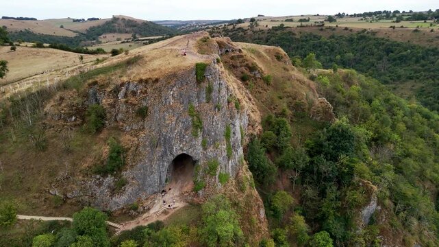 Thor's Cave is a dramatic natural limestone cavern set high in a steep crag overlooking the Manifold Valley in the Staffordshire Peak District, UK. 4k drone footage. 