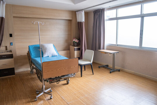 Hospital room interior, empty patient room with bed and window, calm modern ward space