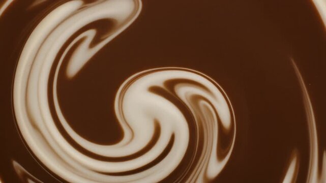 Thick cream swirls into dark liquid, forming smooth marbled tendrils under soft overhead lighting, with cream white and espresso brown tones creating cozy cinematic fluid motion.