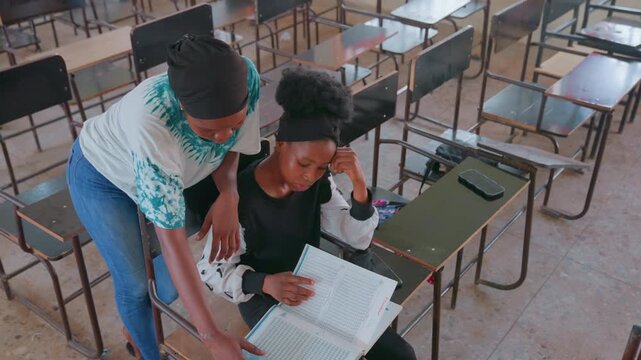 Mother supports anxious student attentively. Focused study session with nurturing teacher guidance. Peaceful study setting where educator comforts nervous learner through critical exam processes