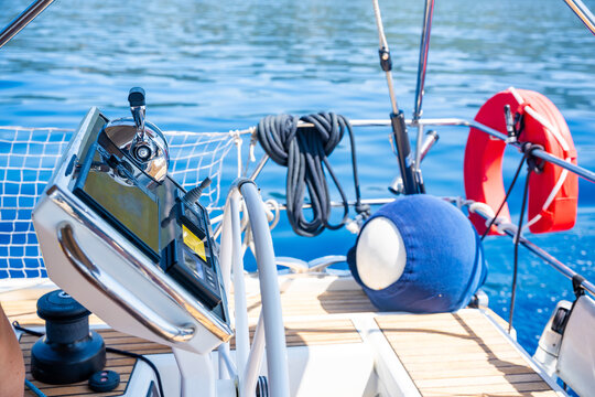 Modern yacht helm station with GPS chartplotter and engine control at sea. Advanced marine navigation technology for safe sailing and vessel operation.