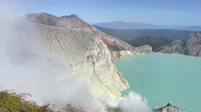Acidic sulfur lake, smoking crack of Ijen volcano on Java island, Indonesia.