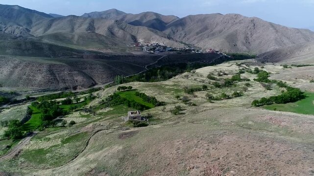 Detailed drone perspective captures fire temple ruins nestled in valley with surrounding hills and natural vegetation.