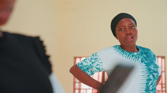Black mother offering patient feedback to child in closeup classroom scene, expressive face and hands on hips, script or notes visible, coaching tone with constructive guidance, candid emotional