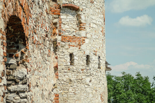 Old stone castle tower with red brick window details real photography