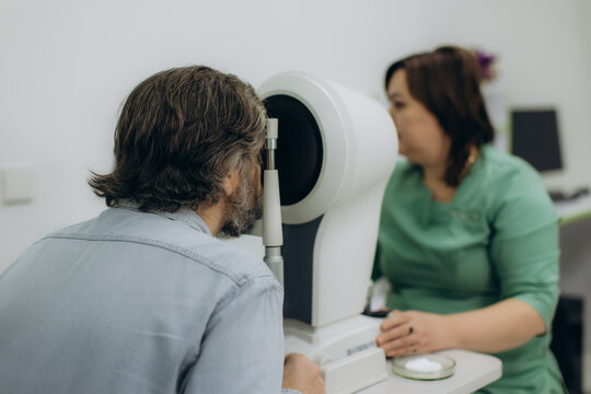 Patient undergoing eye exam in ophthalmology cabinet